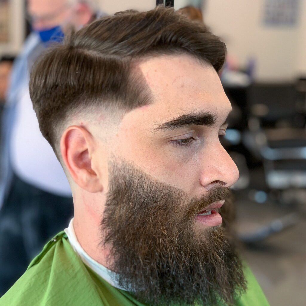 Fresh skin fade haircut with sharp beard trim at GG101 barbershop in Kyle, TX